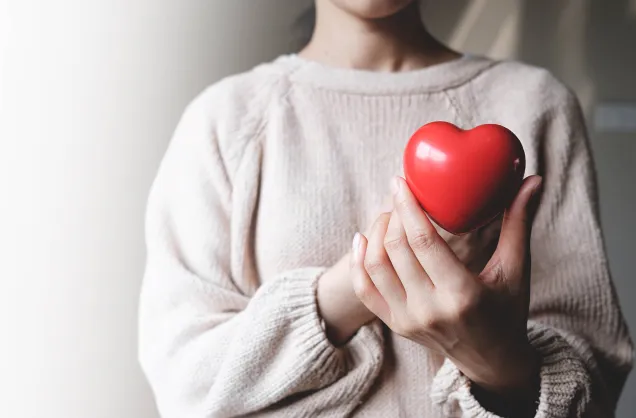 woman holding red heart 